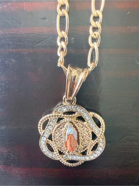 Our Lady of Guadalupe gold tone
& Rhinestone Medallion on 22” 
Titanium stainles